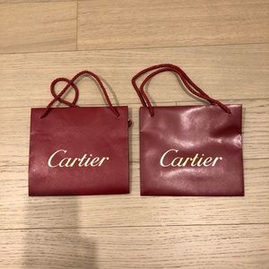 Two Cartier jewellery red bags